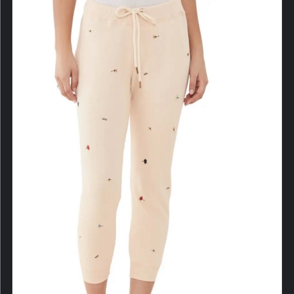 THE GREAT. 
The Cropped Sweatpants With Tossed Floral Embroidery - Whisper Pink
